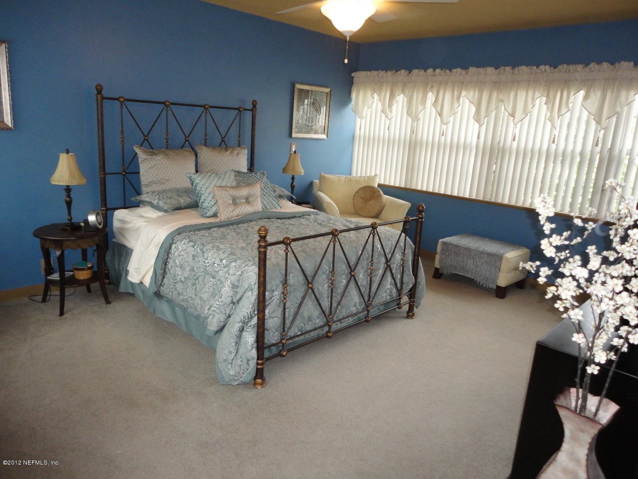 875 Waterman Road North Jacksonville, FL 32207 - Photo 5 of 27 a bed sitting in a bedroom next to a window