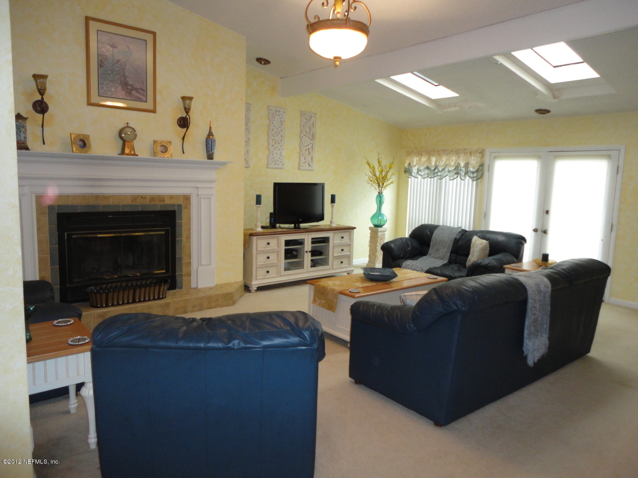 875 Waterman Road North Jacksonville, FL 32207 - Photo 6 of 27 a living room with furniture a fireplace and a flat screen tv