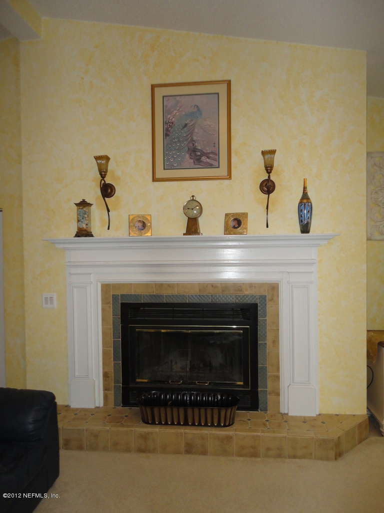 875 Waterman Road North Jacksonville, FL 32207 - Photo 7 of 27 a living room with a fireplace and a couch