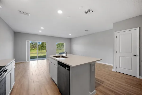 a kitchen with a wooden floor and a wooden floor