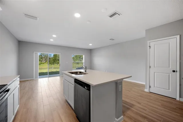 a kitchen with a wooden floor and a wooden floor