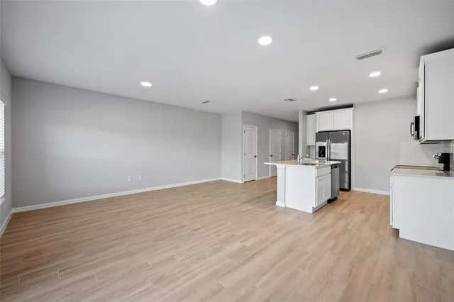 a view of a kitchen with microwave and cabinets