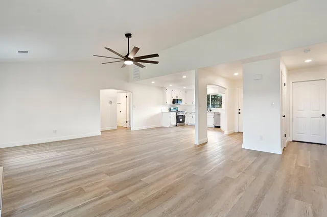 a view of a livingroom with a hardwood floor and a ceiling fan