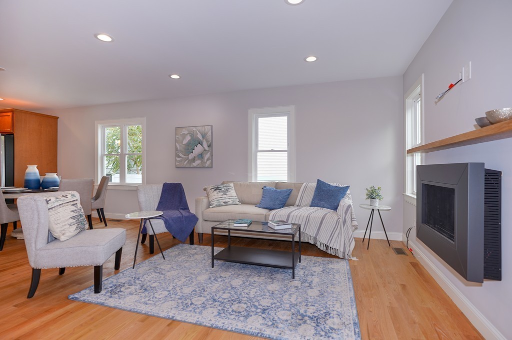 75 Decatur Street, Unit 3 Arlington, MA 02474 - Photo 5 of 20 a living room with furniture lamp and a fireplace