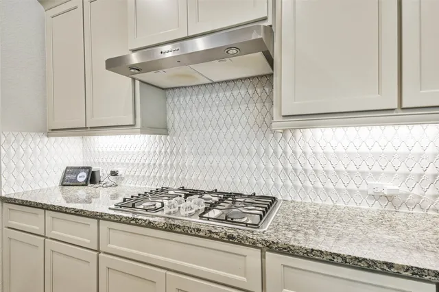 a stove top oven sitting inside of a kitchen