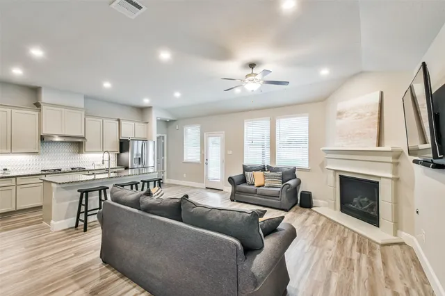 a living room with furniture wooden floor and a fireplace