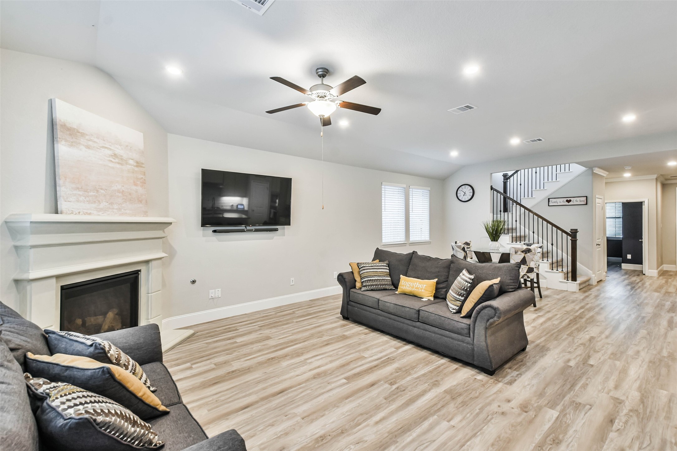 22095 Volante Drive Spring, TX 77386 - Photo 16 of 47 a living room with furniture a flat screen tv and a fireplace