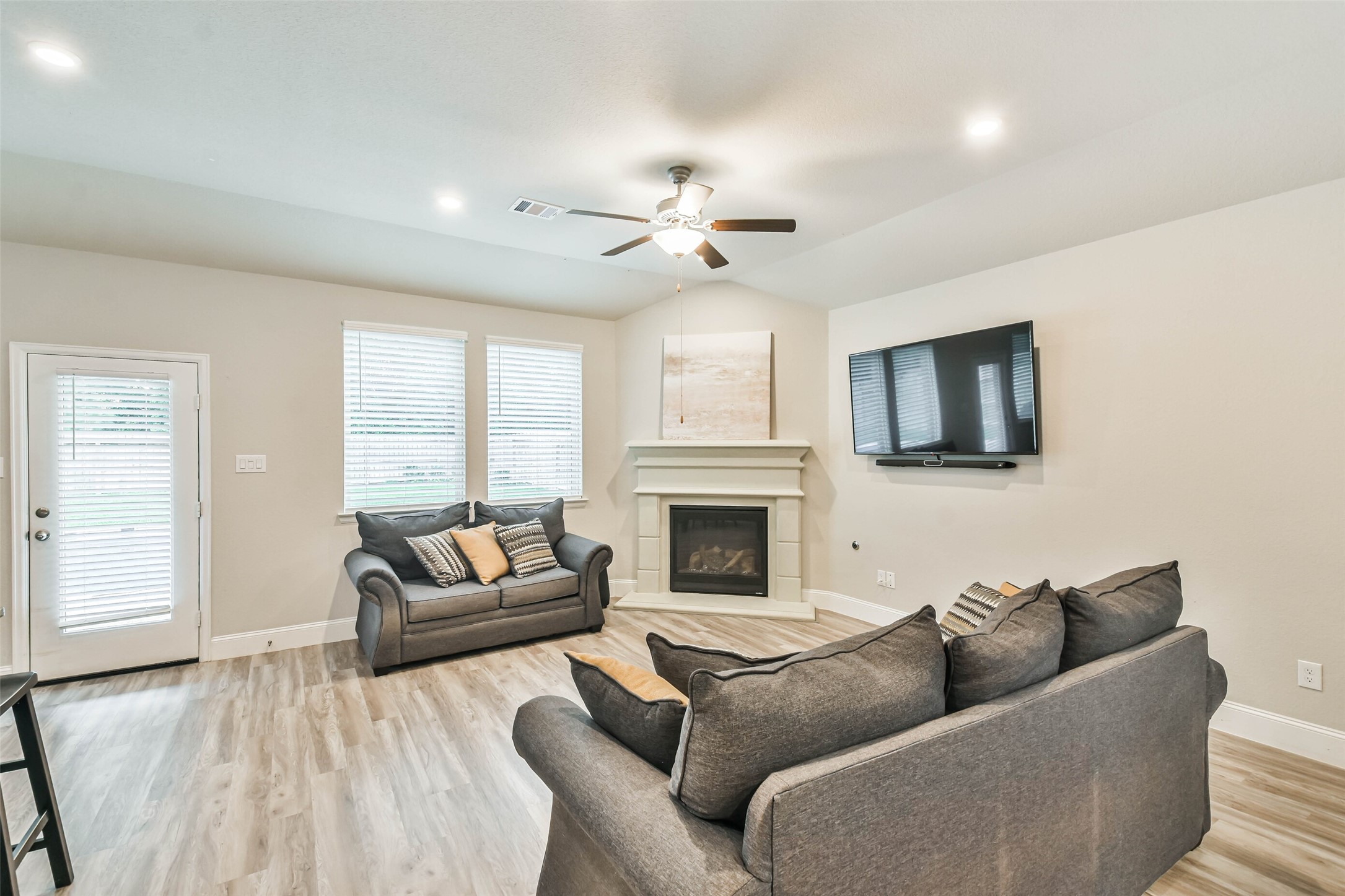 22095 Volante Drive Spring, TX 77386 - Photo 19 of 47 a living room with furniture a fireplace and a flat screen tv