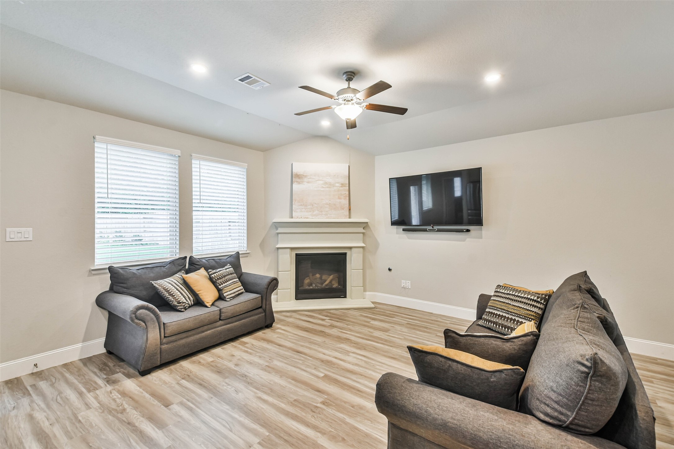 22095 Volante Drive Spring, TX 77386 - Photo 20 of 47 a living room with furniture a fireplace and a flat screen tv
