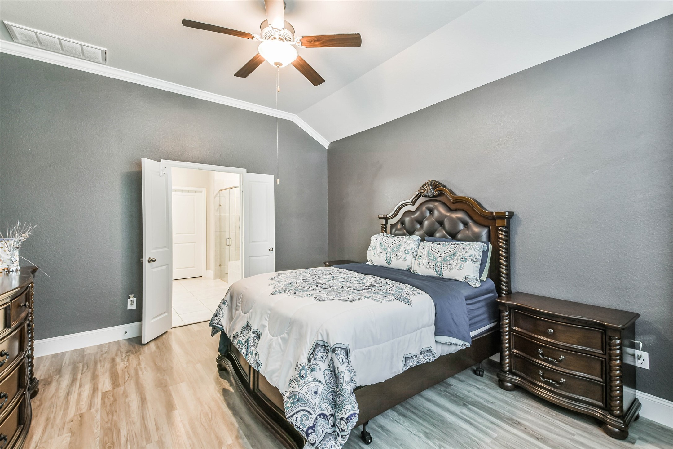 22095 Volante Drive Spring, TX 77386 - Photo 22 of 47 a bedroom with a bed and a chandelier