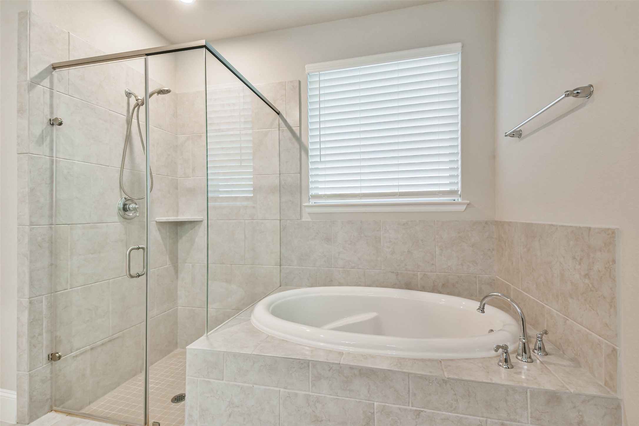 22095 Volante Drive Spring, TX 77386 - Photo 24 of 47 a bathroom with a white bath tub and a shower