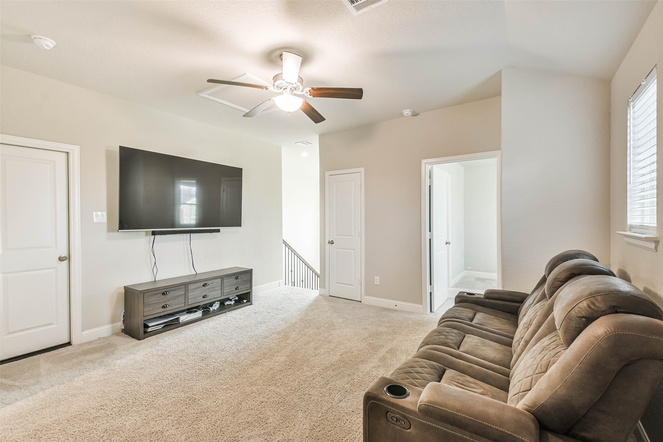 22095 Volante Drive Spring, TX 77386 - Photo 30 of 47 a living room with furniture and a flat screen tv