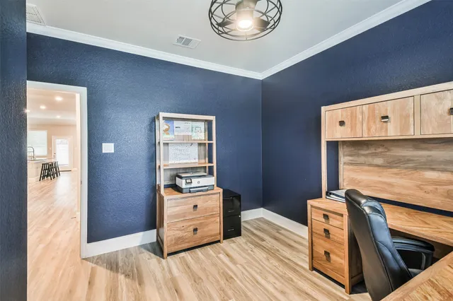 a view of a bedroom with furniture and wooden floor