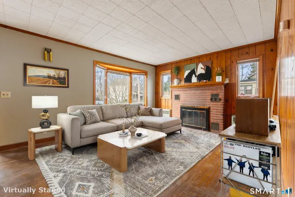 a living room with furniture a fireplace and a flat screen tv