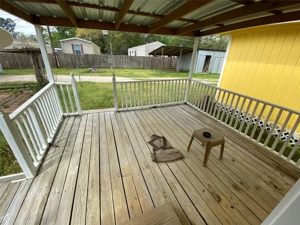 a view of balcony with wooden floor