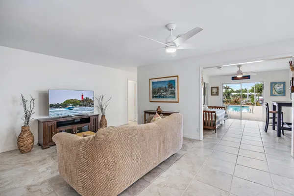 a living room with furniture and a painting on the wall