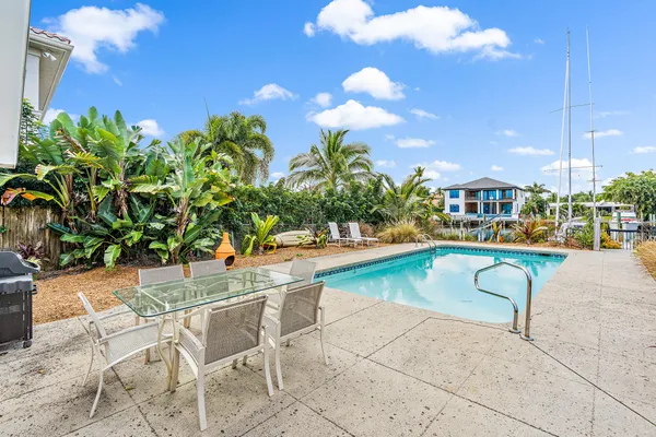 a view of a swimming pool with outdoor seating