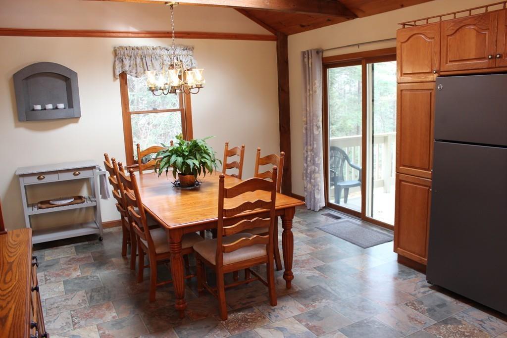 75 H Foote Road Charlton, MA 01507 - Photo 5 of 24 a dining room with furniture a chandelier and wooden floor