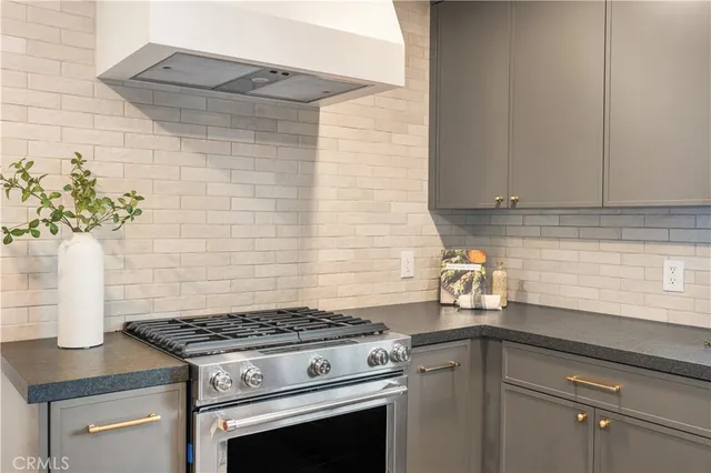 a stove top oven sitting inside of a kitchen