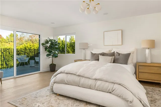 a spacious bedroom with a bed and a large window