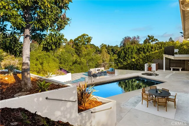 a view of a patio with table and chairs and potted plants