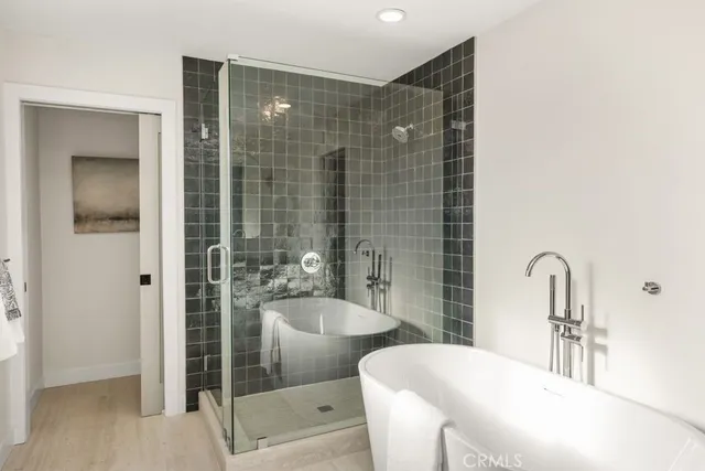 a bathroom with a tub and shower