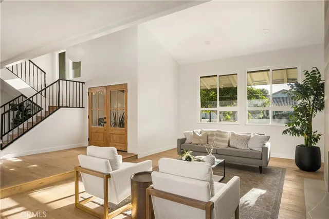 a living room with furniture and flowers