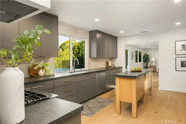 a kitchen with a sink and chairs