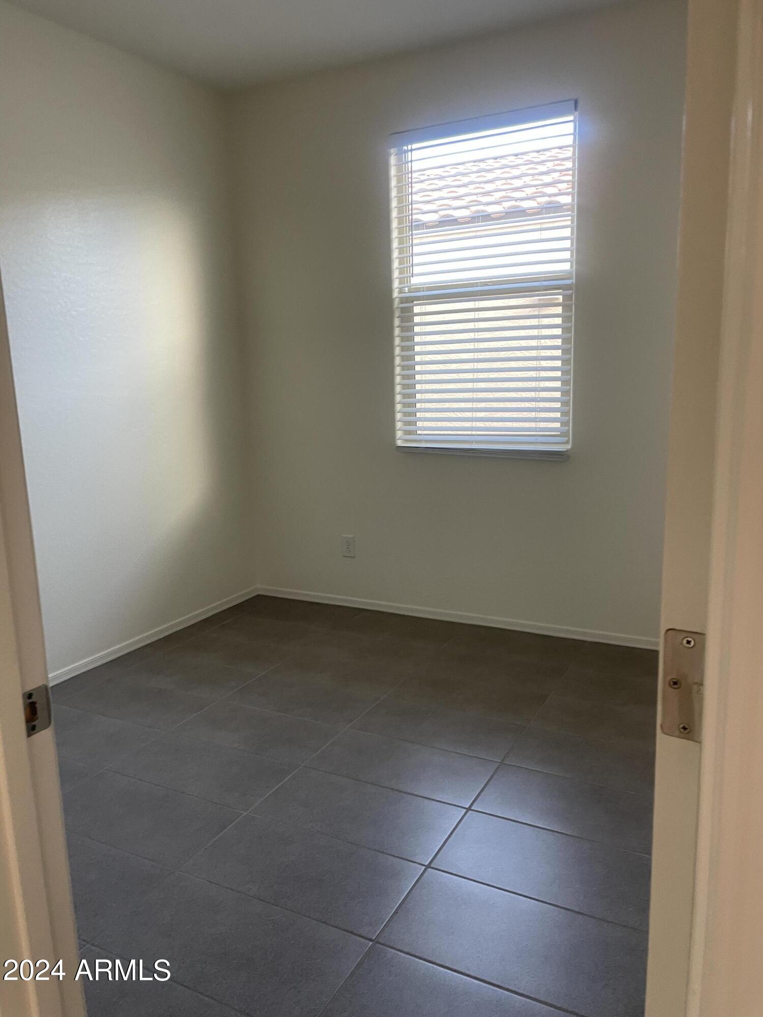 9536 Silo Circle Florence, AZ 85132 - Photo 10 of 12 an empty room with a window