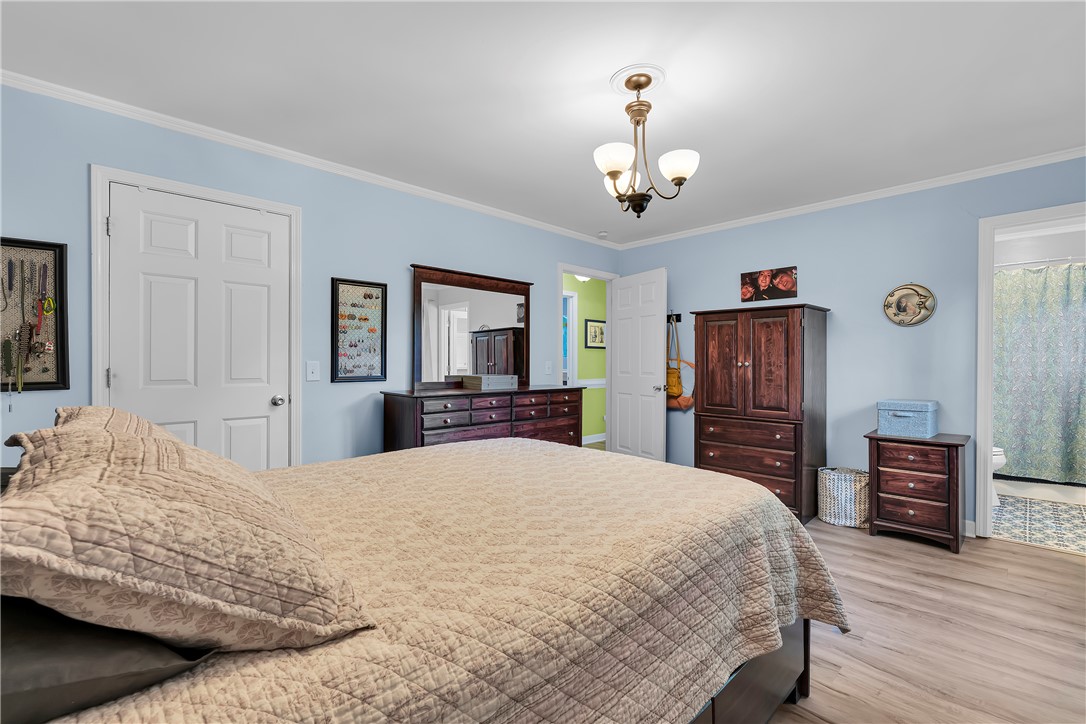 1305 Hanover Road Anderson, SC 29621 - Photo 13 of 29 Smooth wood-plank flooring pairs with crown molding in this peaceful bedroom retreat.