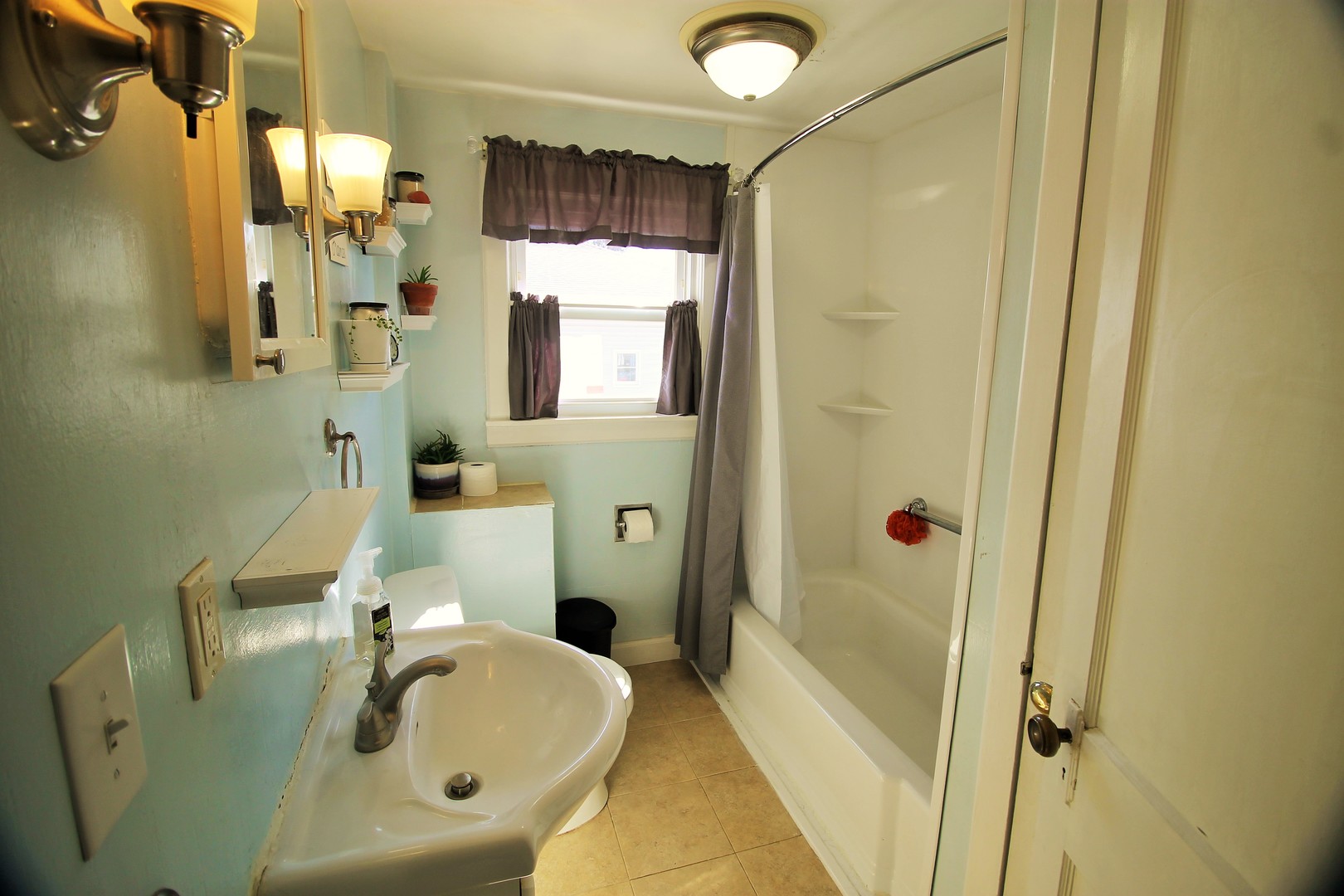 817 South Illinois Street Geneseo, IL 61254 - Photo 12 of 20 a bathroom with a sink a toilet and shower
