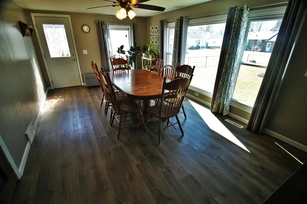a view of a dining room with furniture window and wooden floor