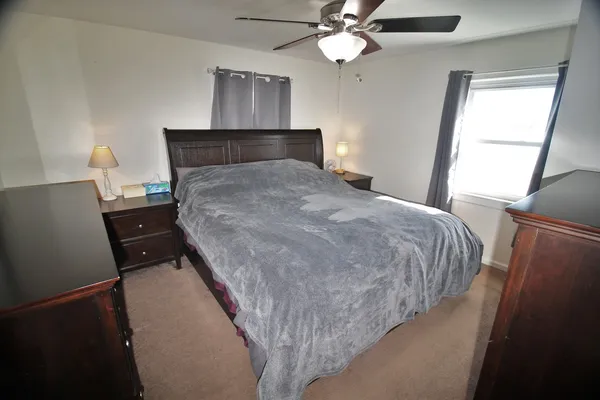 a bedroom with a bed and window