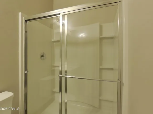 a bathroom with a glass shower door