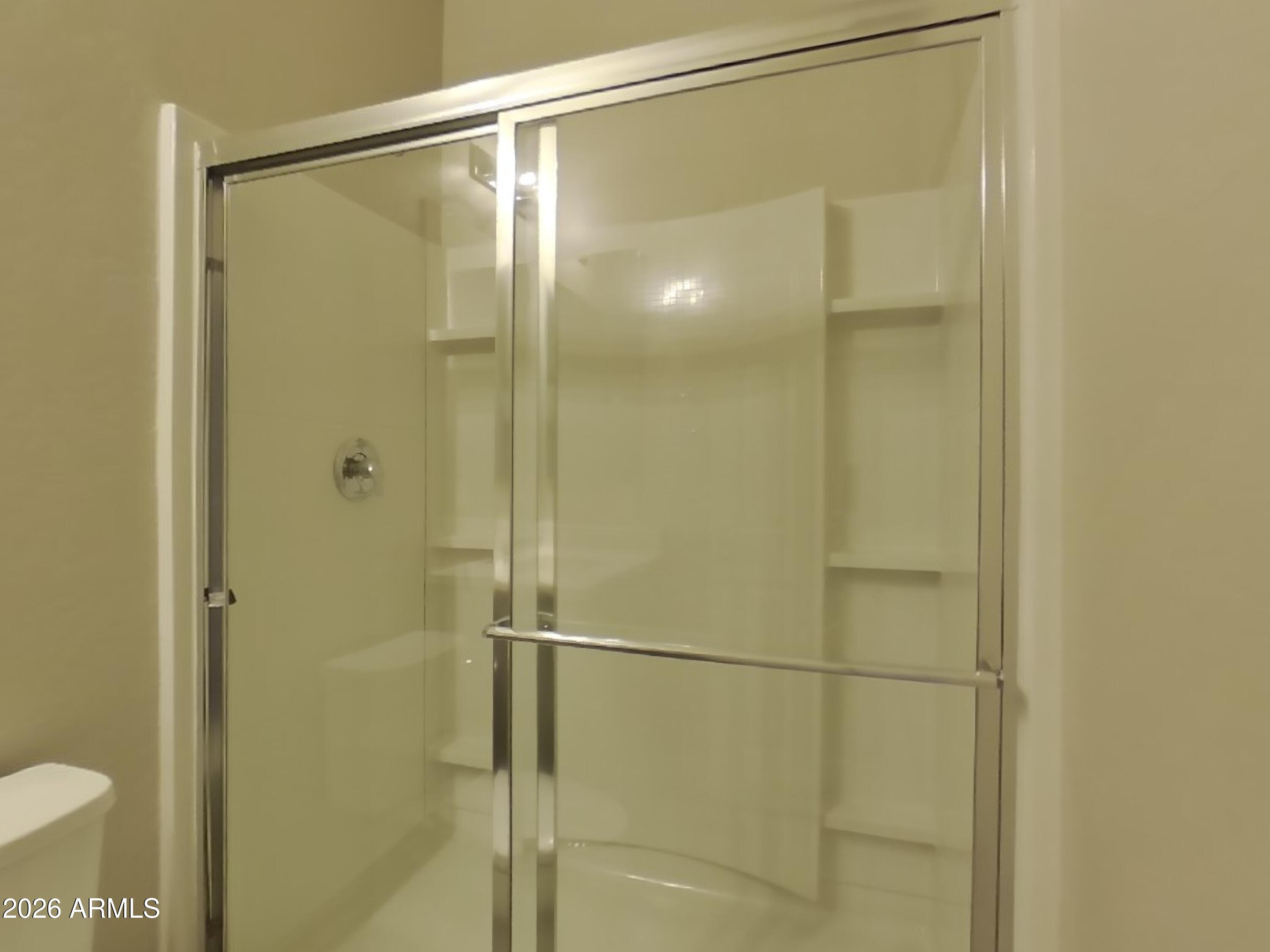 2630 East Danbury Road Phoenix, AZ 85032 - Photo 12 of 17 a bathroom with a glass shower door