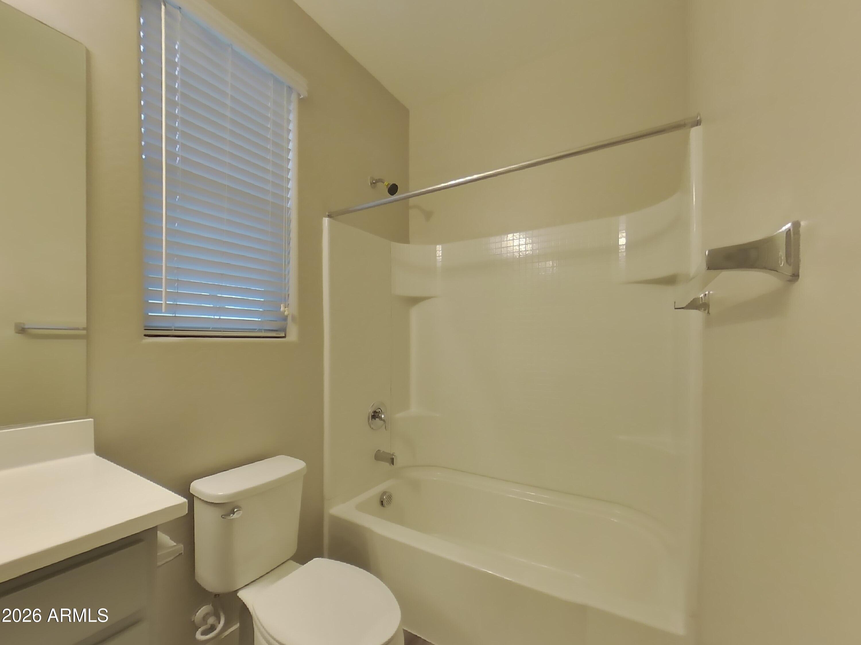 2630 East Danbury Road Phoenix, AZ 85032 - Photo 14 of 17 a bathroom with a toilet and a bathtub