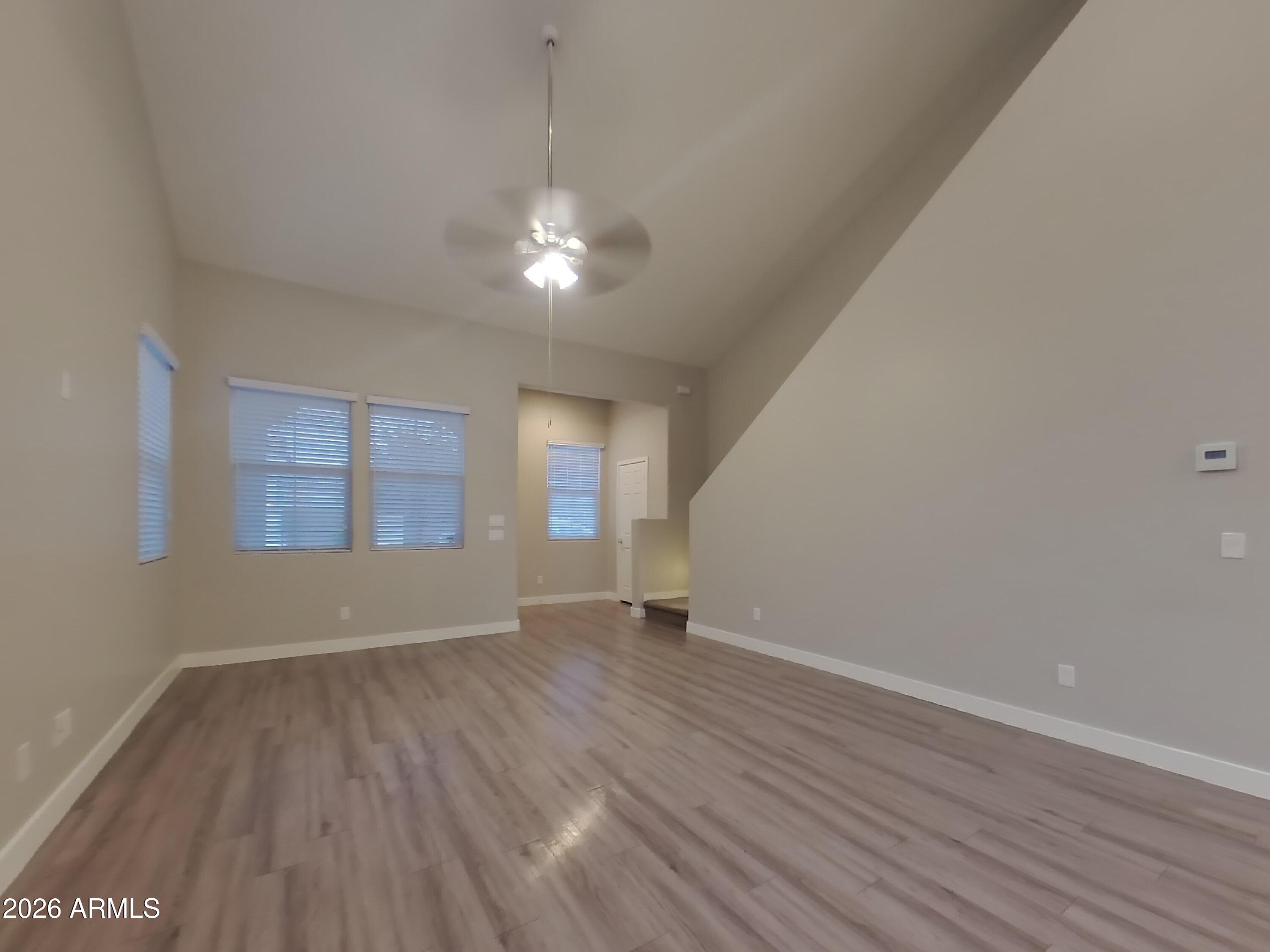 2630 East Danbury Road Phoenix, AZ 85032 - Photo 2 of 17 wooden floor in an empty room with a window