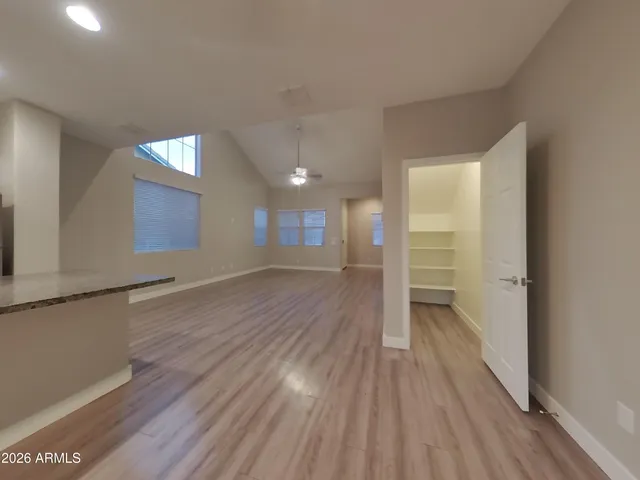 a view of empty room with wooden floor