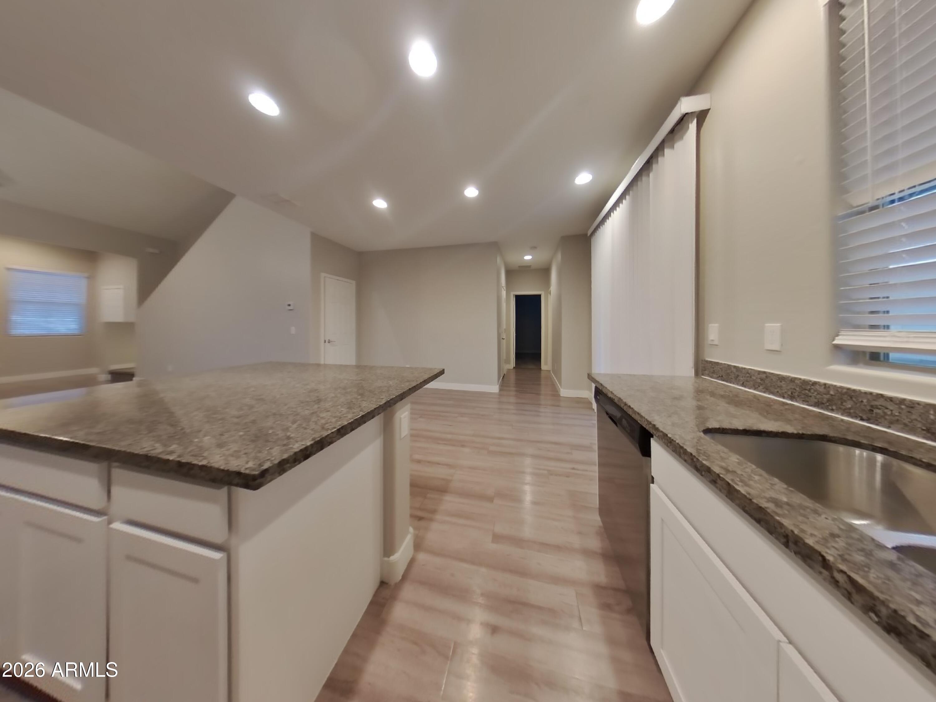 2630 East Danbury Road Phoenix, AZ 85032 - Photo 4 of 17 a kitchen with stainless steel appliances granite countertop a sink counter space and a stove