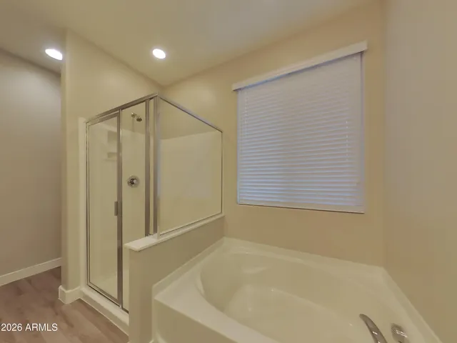 a bathroom with a bathtub and a shower