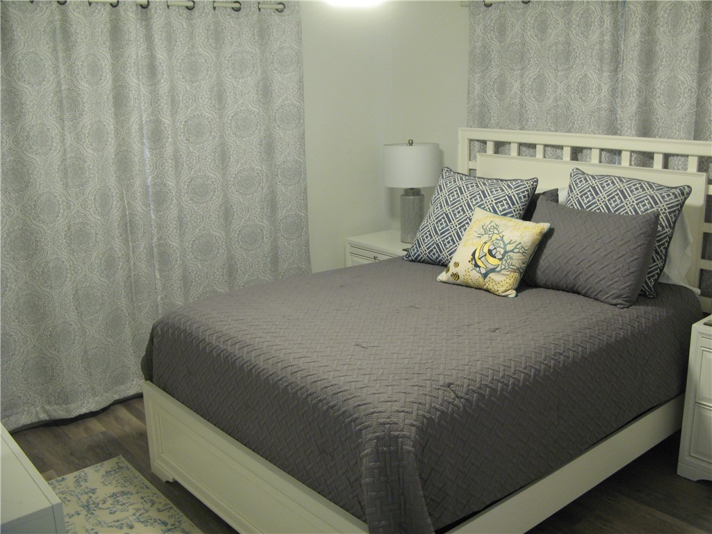 3700 Bay Street Sebastian, FL 32976 - Photo 18 of 35 a bed sitting in a bedroom next to a shower curtain