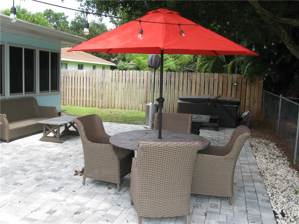 3700 Bay Street Sebastian, FL 32976 - Photo 33 of 35 a view of a patio with a table chairs and a fire pit