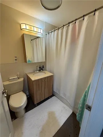 a bathroom with a sink toilet and shower