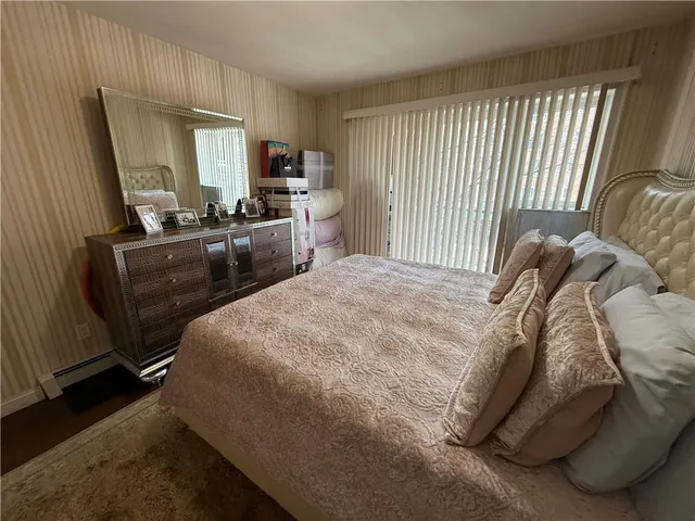a bedroom with a bed and a large mirror