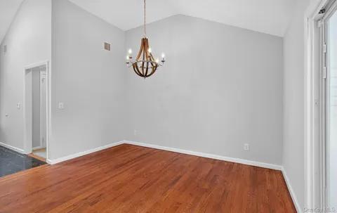 a view of a room with wooden floor and window