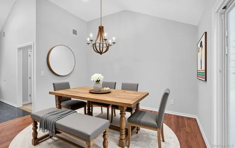 a view of a dining room with furniture and chandelier
