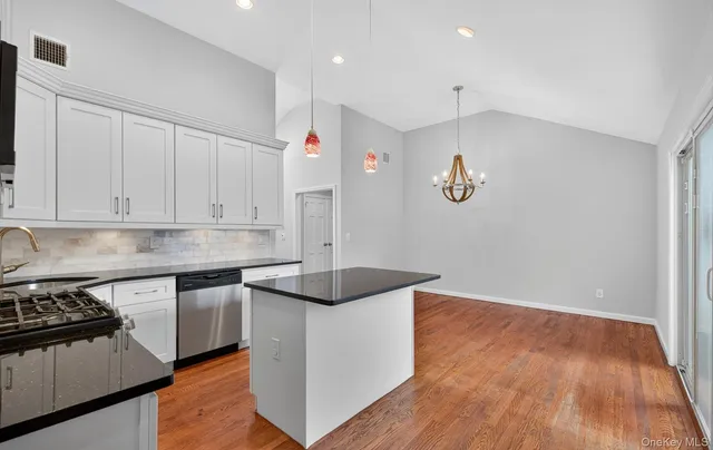 a kitchen that has a sink and a stove in it