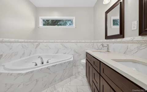 a bathroom with a bathtub and a sink