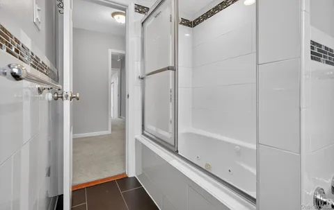 a bathroom with a shower and a glass door