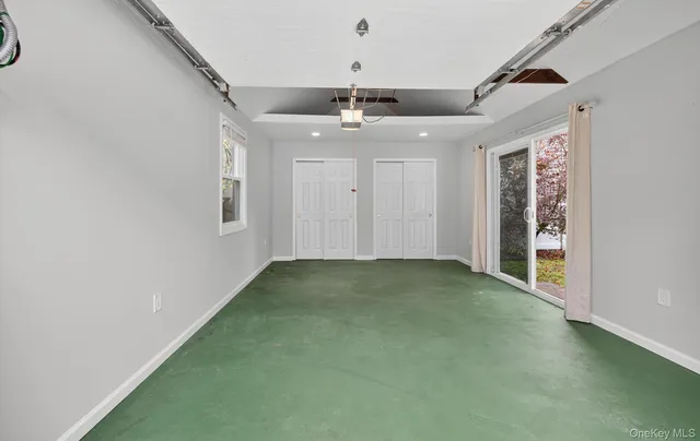 a view of a livingroom with a ceiling fan and window